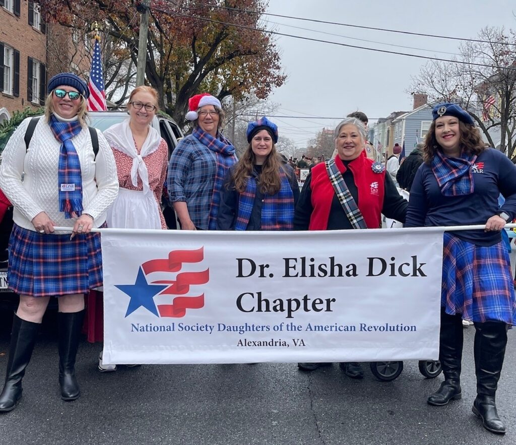 Dr. Elisha Dick Chapter Members holding parade banner