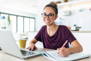 Woman smiling, working at computer